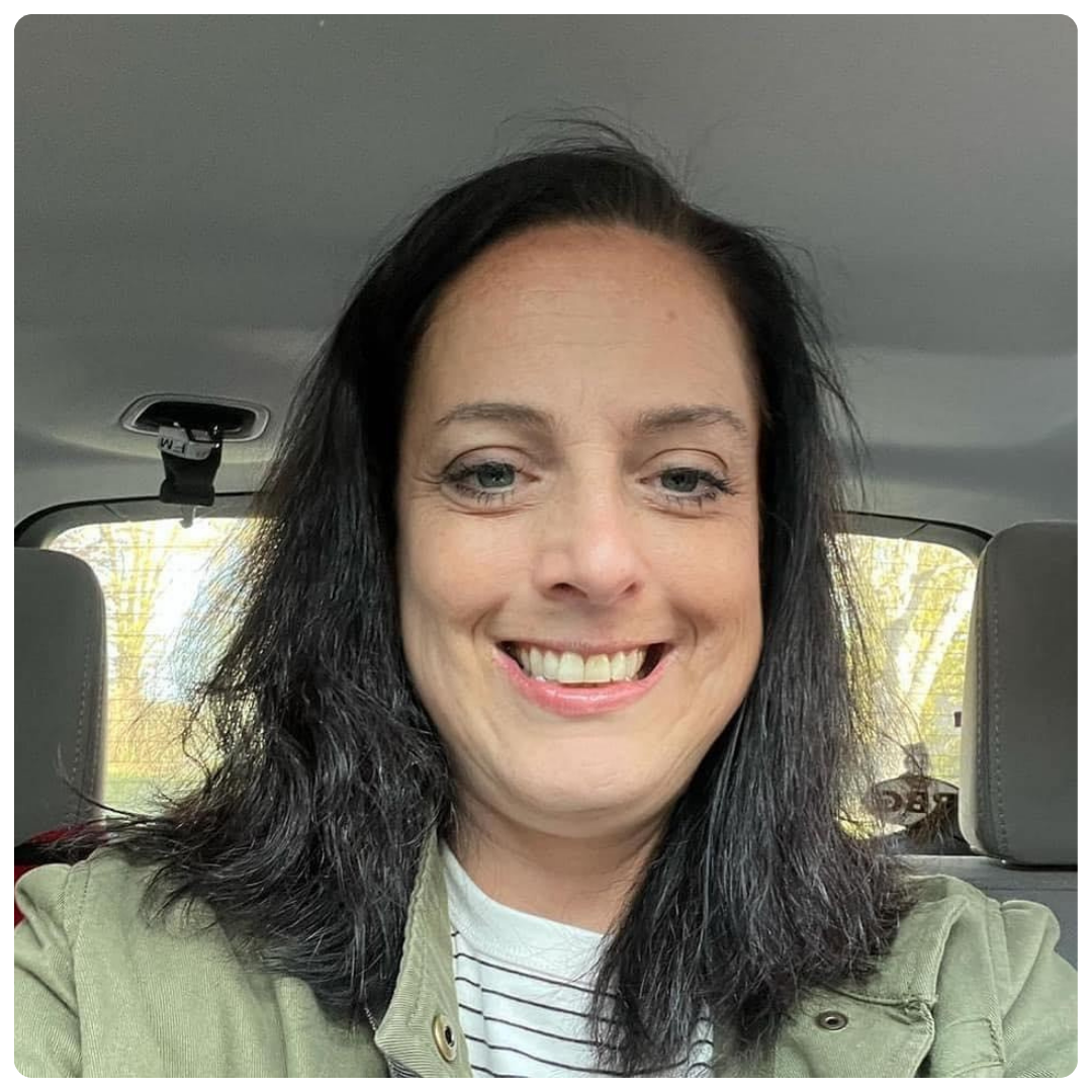 Danielle, a white woman smiling in a car.