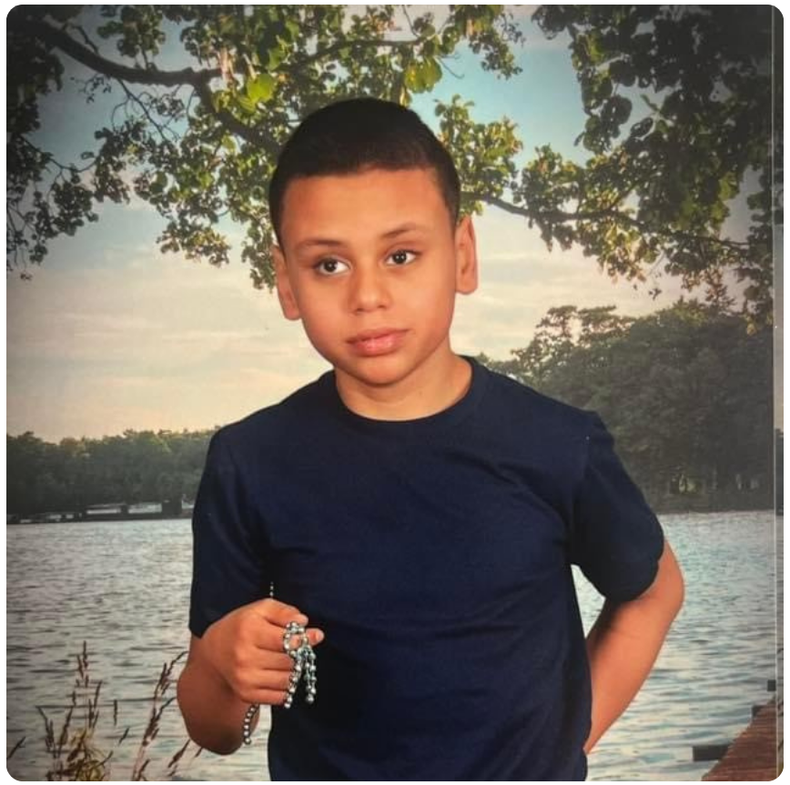 Ziejen, a young student posing for a yearbook photo holding stim toy.