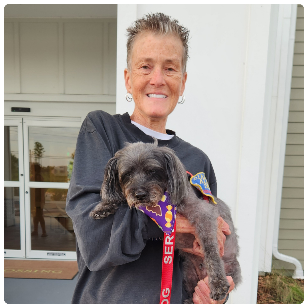 Bobbi holding her dog Auggie.