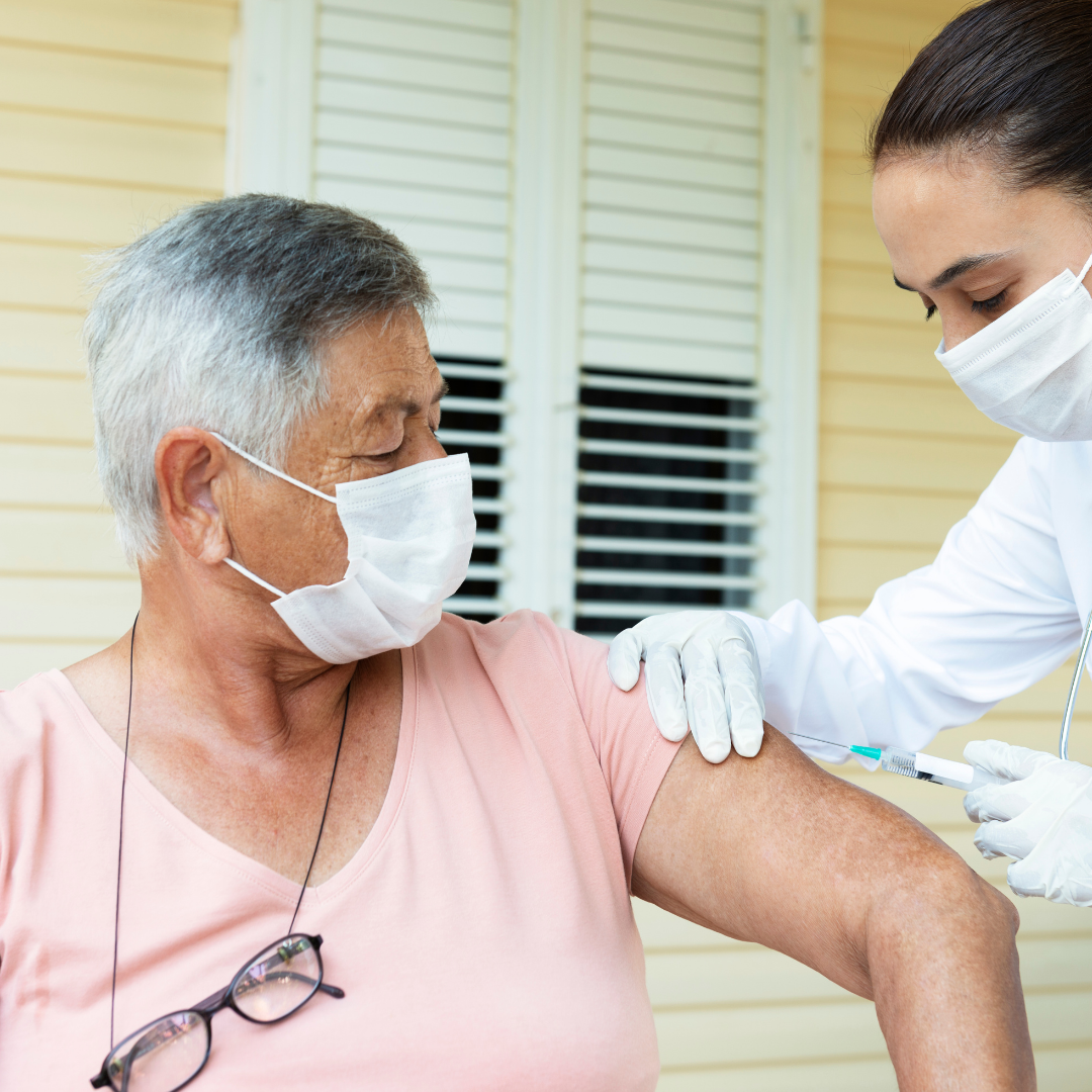 person wearing a mask getting a vaccine