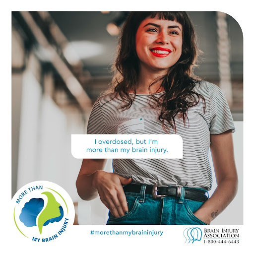 Image description: Photograph of a white woman with brown hair and red lipstick wearing a white and gray striped shirt tucked into jeans. Blue text in a white box reads: “I overdosed, but I’m more than my brain injury.” Across the bottom there is a Brain Injury Association symbol with the phone number (1-800-444-6443) in blue and black text with a more than my brain injury hashtag and graphic of a person's side profile in front of a cloud.