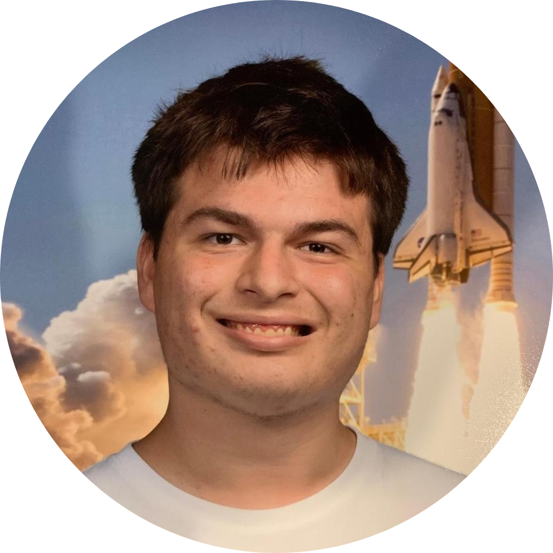 Client Jax, with light skin, short brown hair, white t-shirt smiling in front of space shuttle background.