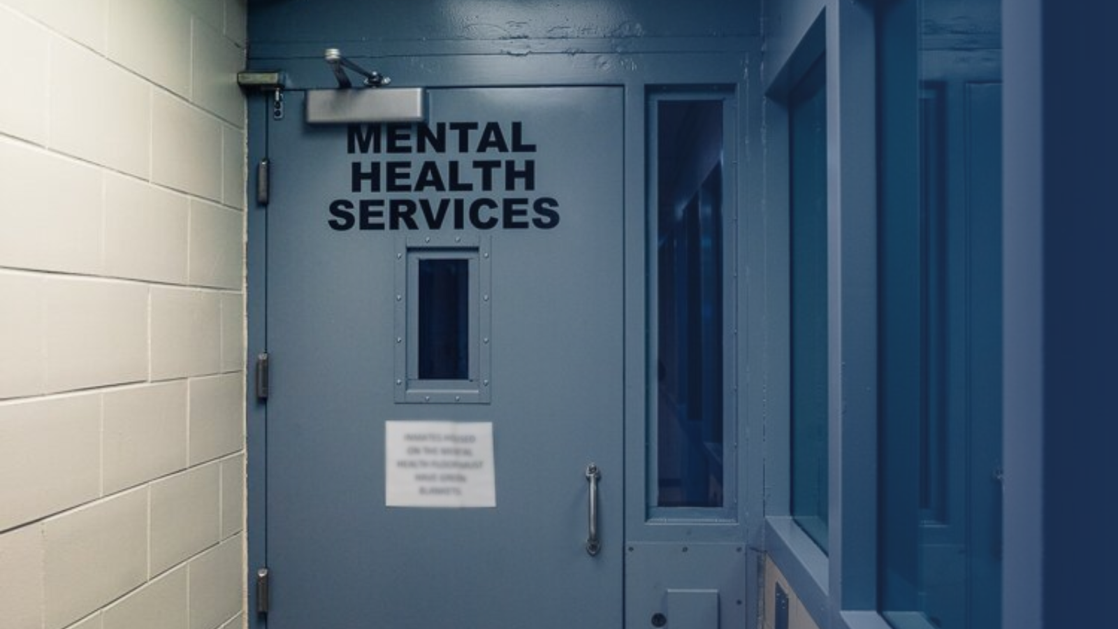 Door inside jail that reads: Mental Health Services