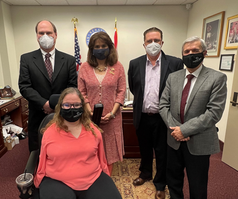 D R F staff and board members pose for photo with a Florida senator